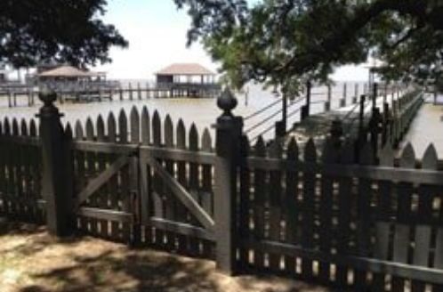 Cooper Fence Company black wood fence and gate